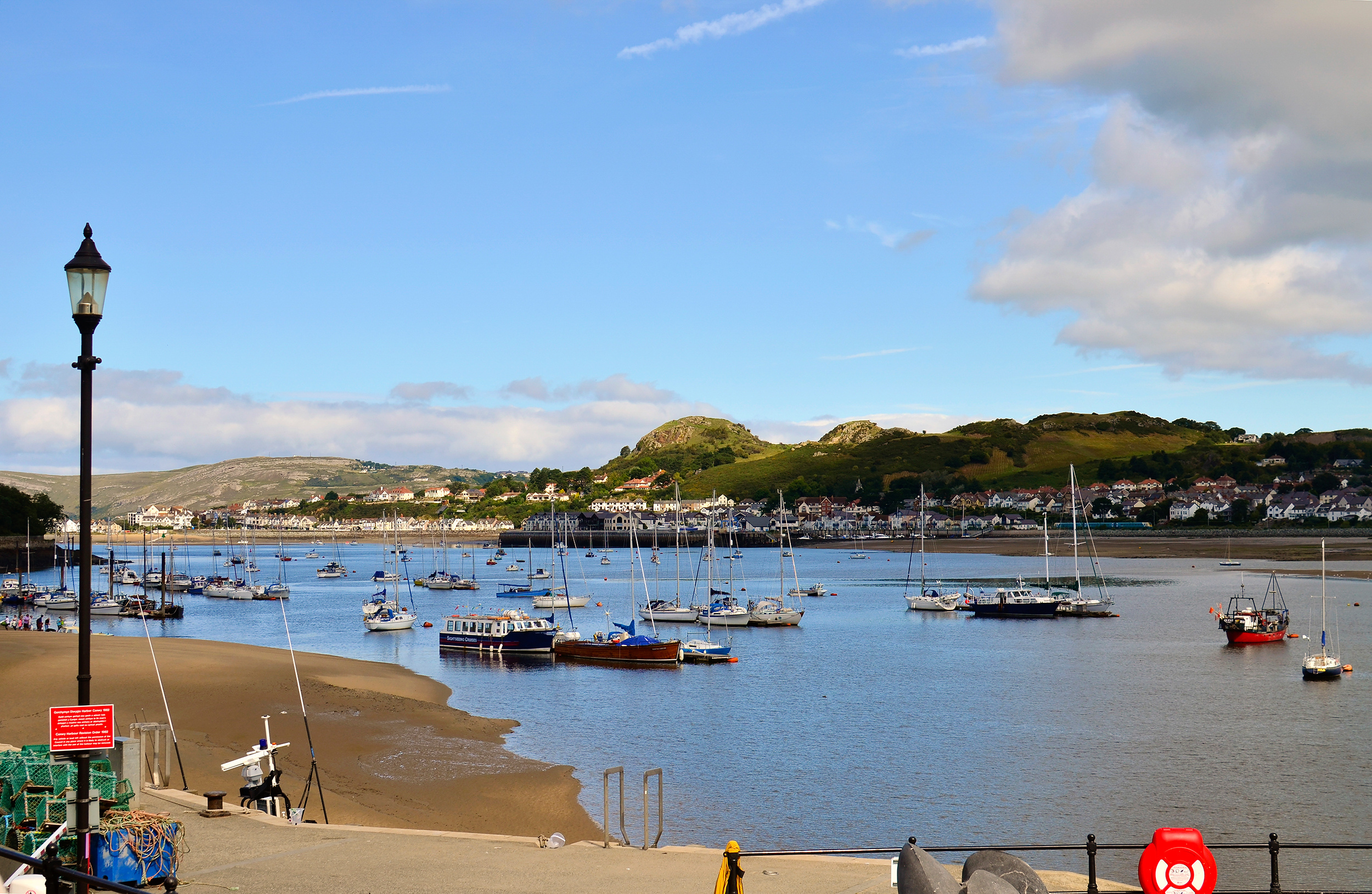 The view on a bay with a lot of boats on the river Conwy during